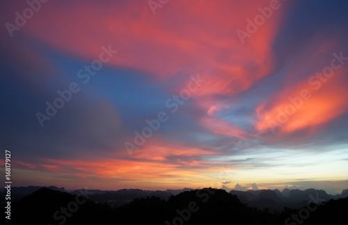 Low key image of sunset over the mountains. Krabi, Thailand. © Ilya Sviridenko