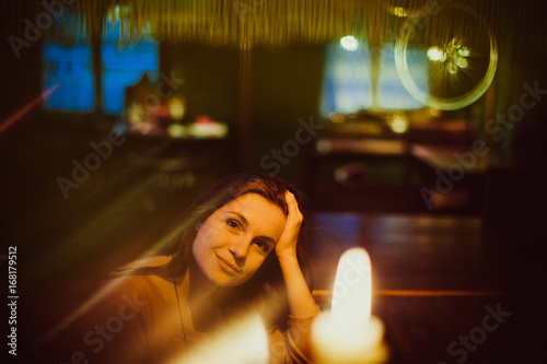 Pretty woman sits at the bar in a restaurant photo