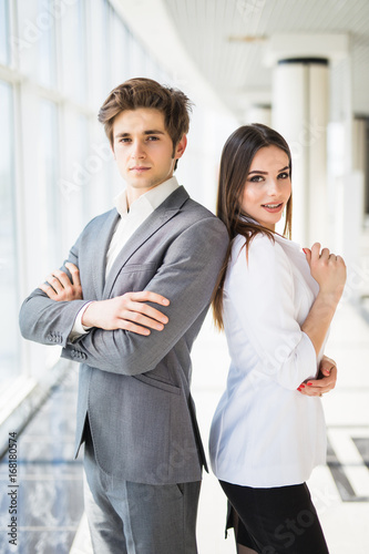 Confident business team of man and woman standing with crossed hands, team spirit concept, couple of success business people ready to act, business manager and employee,ready to implement plans