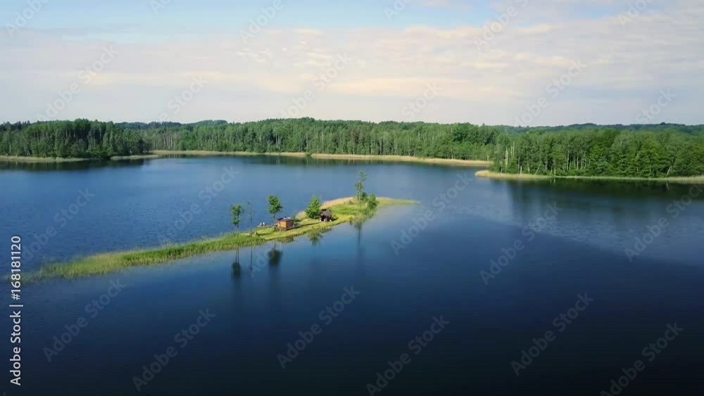 Young just married couple enjoying summer day on pier near by summer house which is located on small island on the lake. Upper view from drone. Young just married couple enjoying summer day on pier near by summer house which is located on small island on the lake. Upper view from drone.