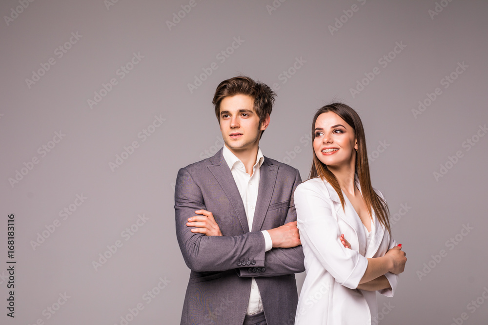 Young smiling business woman and business man isolated on gray background Young smiling business woman and business man isolated on gray background