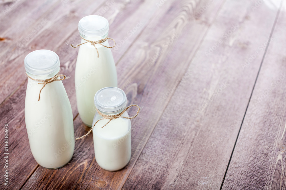 bottles of milk on a wooden rustic table. copy space bottles of milk on a wooden rustic table. copy space