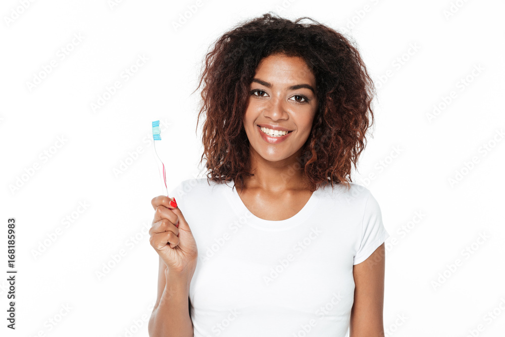 African lady holding toothbrush. African lady holding toothbrush.
