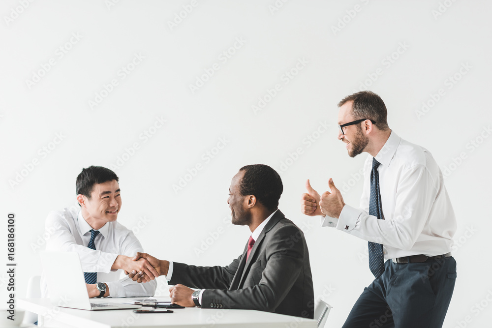 multiethnic businessmen shaking hands multiethnic businessmen shaking hands