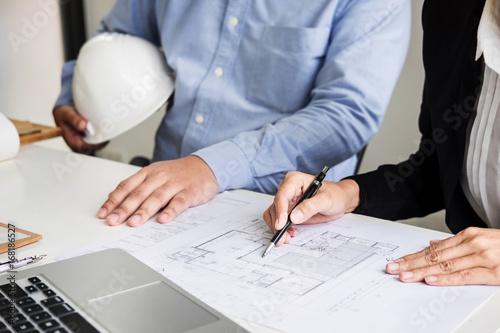  Person's engineer Hand Drawing Plan On Blue Print with architect equipment
