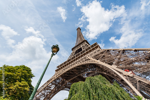 Eiffel tower and lamppost against blue sky in Paris, France