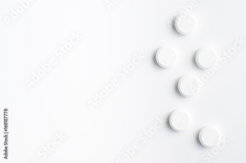 White pills on white background