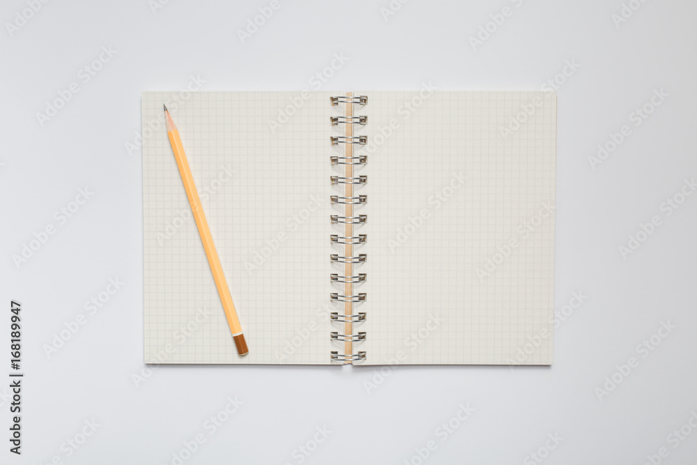 School notebook with yellow pencil School notebook with yellow pencil