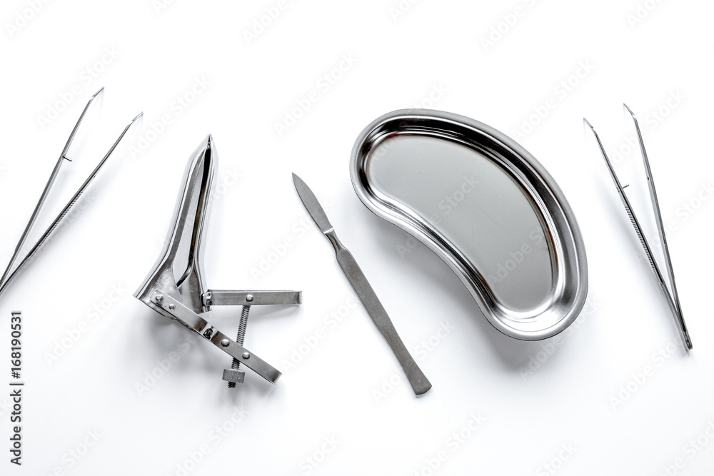 instruments of gynecologist on white background top view instruments of gynecologist on white background top view