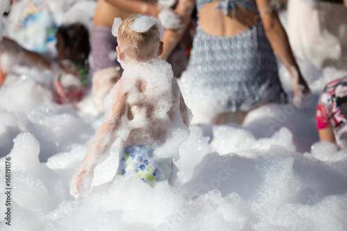 Youth at a foamy party on the beach