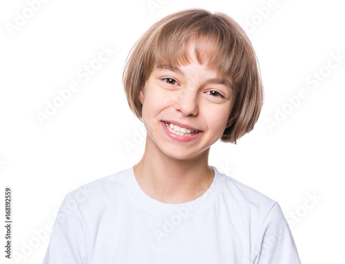 Attractive caucasian girl, isolated on white background. Schoolgirl smiling and looking at camera. Happy child in white t-shirt - emotional portrait close-up. 