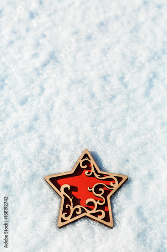 red wooden toy star on snow