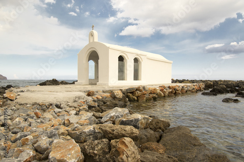 Saint Nicholas small church, amazing white chapel abandoned in the sea on the stones and rocks