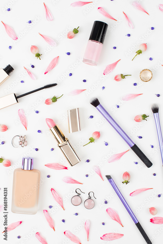 Cosmetics collage with lipstick, brush and other accessories on white background. Composition in gold and pink colors. Flat lay, top view.