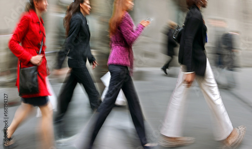 motion blurred business people walking on the street