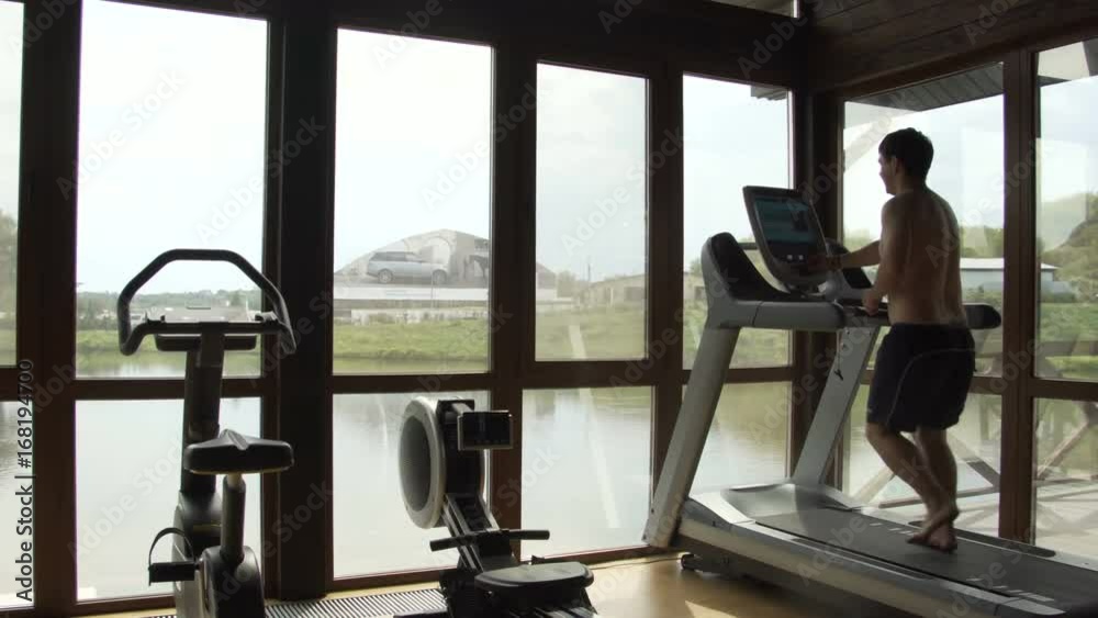Young man jogging in the gym Young man jogging in the gym