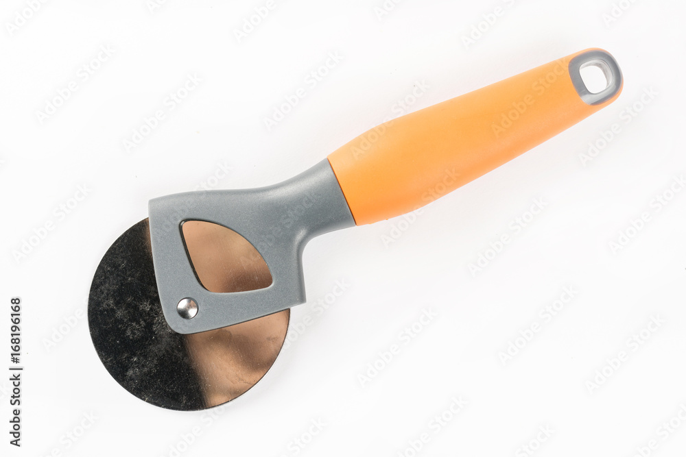 Black and orange round pizza knife isolated over white background with copy space Black and orange round pizza knife isolated over white background with copy space