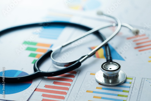 medical statistics and graphic charts with stethoscope photo