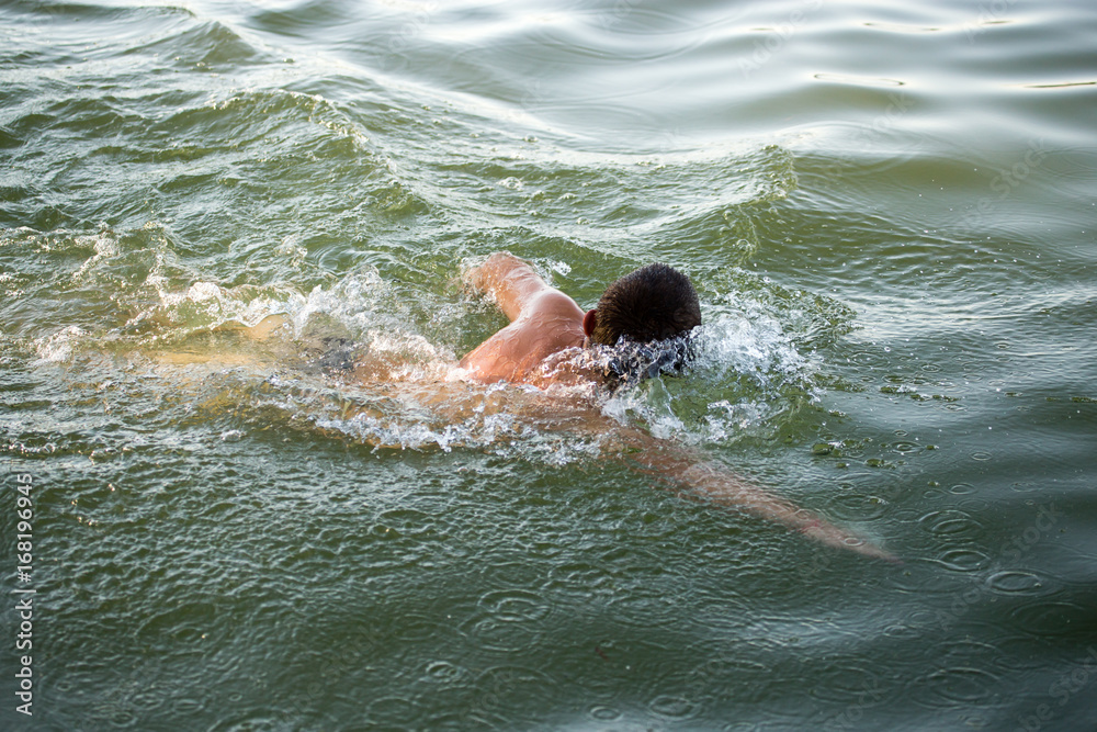 The man is swimming in the lake The man is swimming in the lake