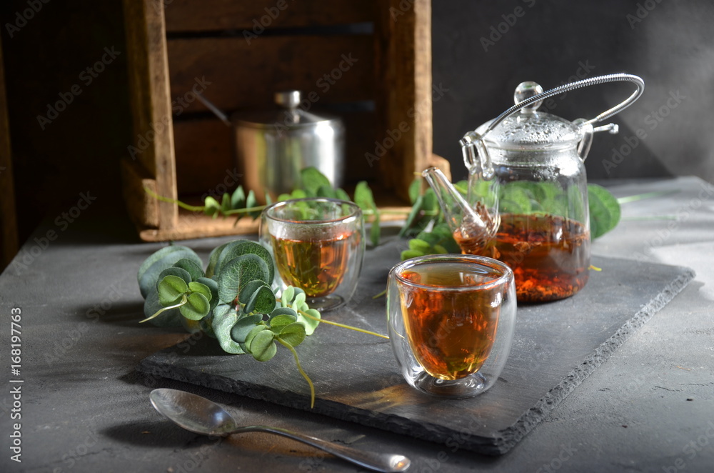 cup of tea in sunny morning. green fresh leaves on the table cup of tea in sunny morning. green fresh leaves on the table