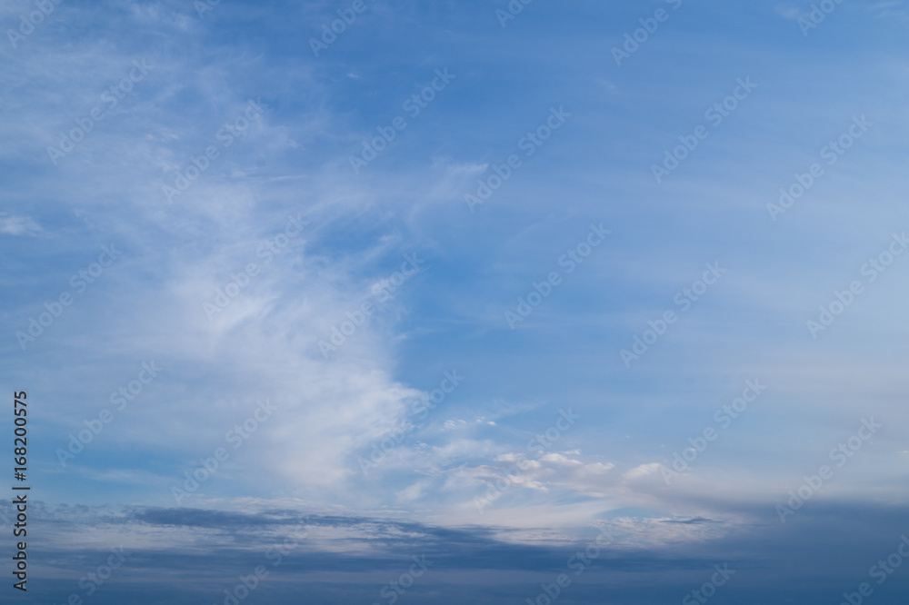 White striped clouds on the blue sky