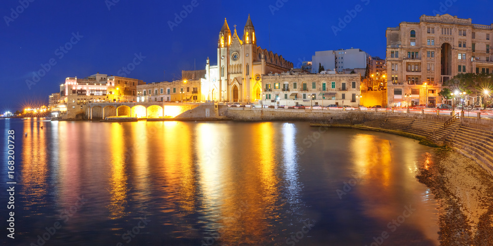 Panorama of Balluta Bay and Neo-Gothic Church of Our Lady of Mount Carmel, Balluta parish church, during evening blue hour, Saint Julien, Malta