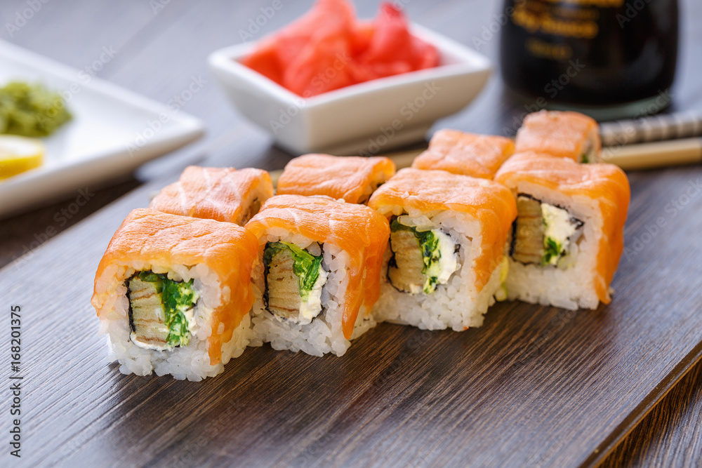 Beautifully decorated sushi on a wooden board. Beautifully decorated sushi on a wooden board.