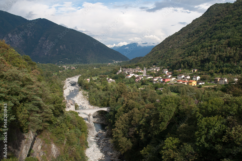 Deep valley with river and mountains. The small mountain town of Intragna in Switzerland. Deep valley with river and mountains. The small mountain town of Intragna in Switzerland.
