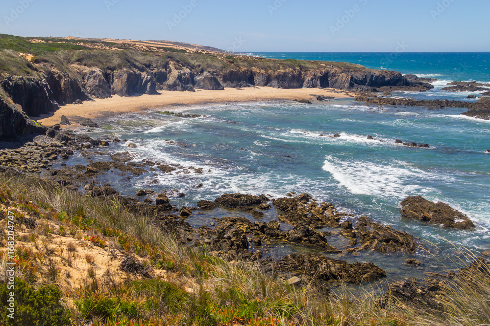 Beach with cliffs and vegetation in Almograve