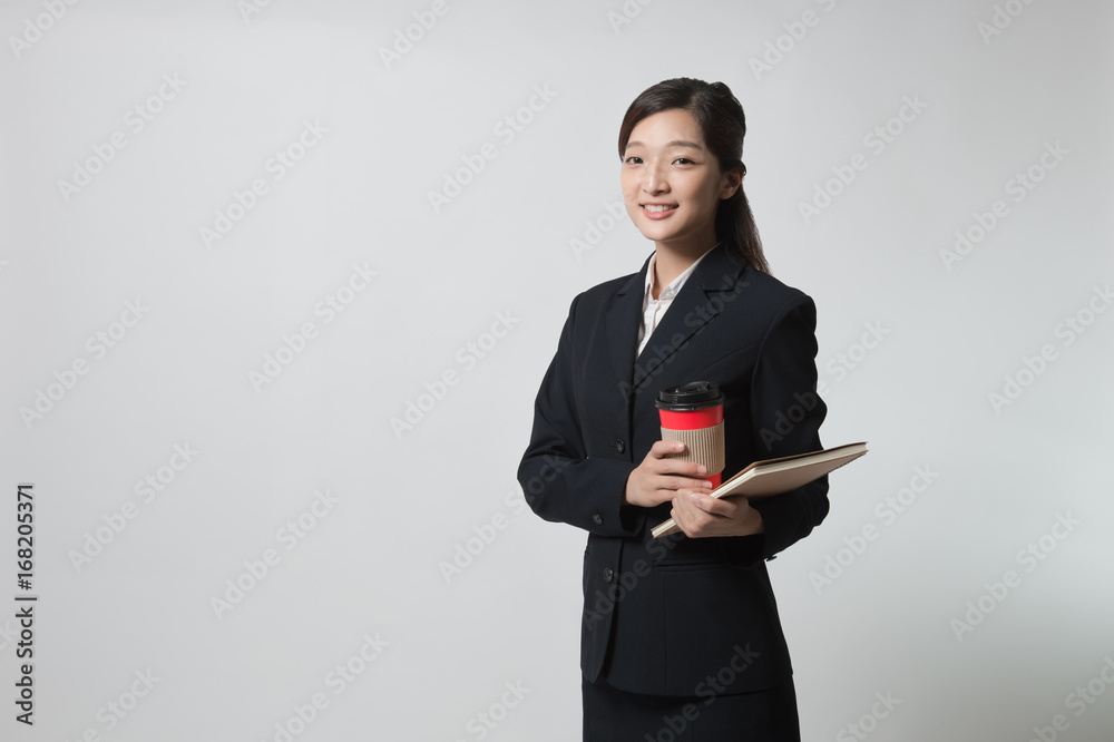 business black woman holding a cup of coffee and files