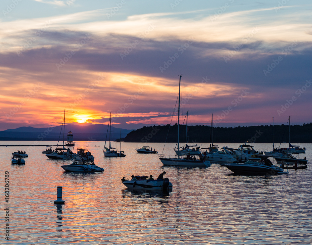 boaters watching the sunset on Lake Champlain on a summer evening
