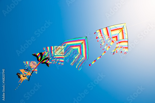 flying kites with blue sky background  photo