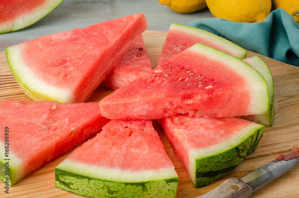 Slices of watermelon on a wood cutting board