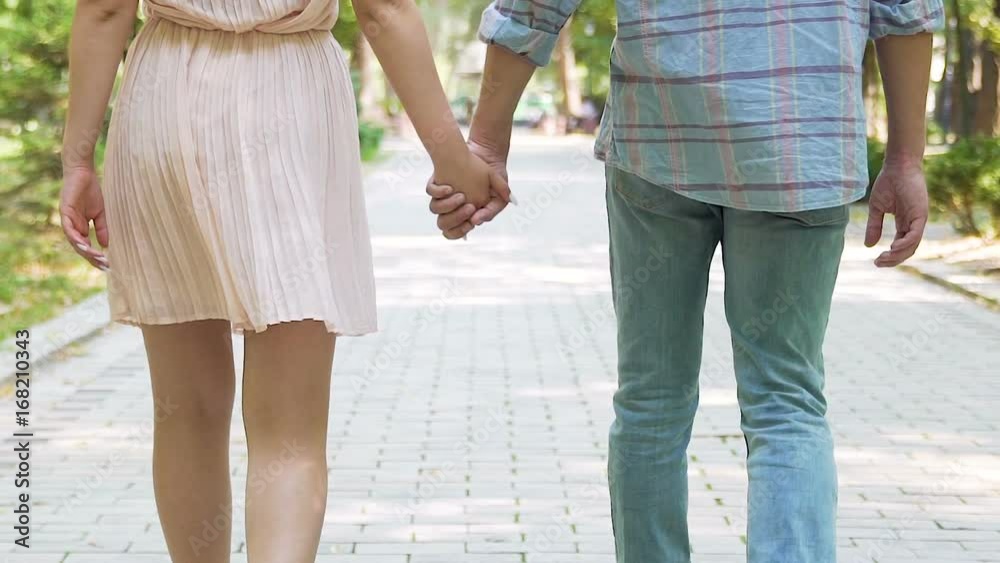 Young man taking beloved woman by hand and walking to meet parents, slow-mo Young man taking beloved woman by hand and walking to meet parents, slow-mo
