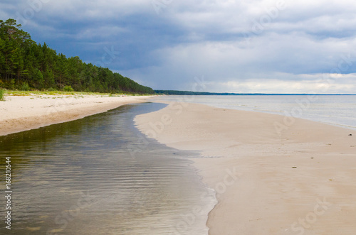Fototapeta Naklejka Na Ścianę i Meble -  Baltic Sea Beach on Summer Day with Rain Clouds Panorama. Latvia, Gulf of Riga.