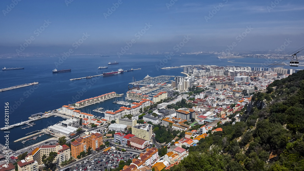 an aerial view of Gibraltar, its marina and the Mediterranean sea as seen from the Rock of Gibraltar