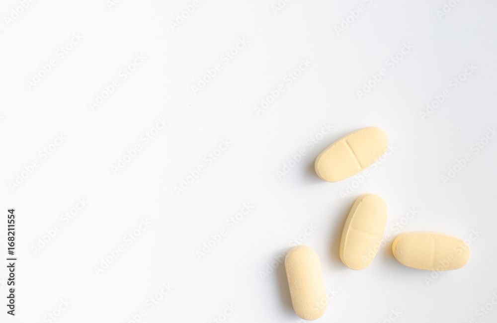 Yellow pills on white background Yellow pills on white background