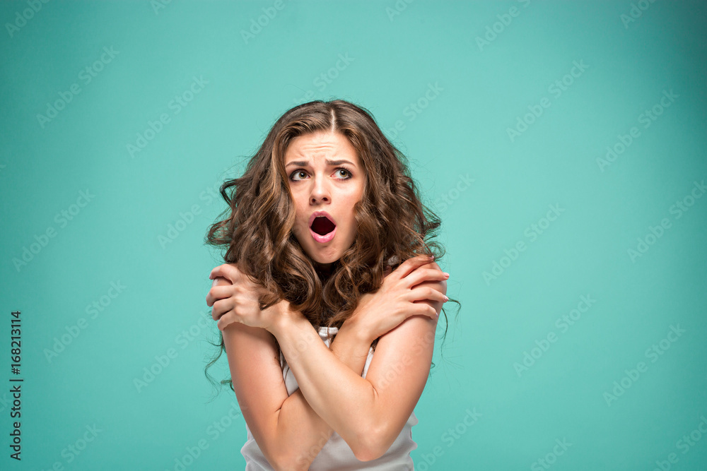 Portrait of young woman with shocked facial expression