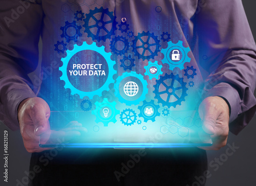 Business, Technology, Internet and network concept. Young businessman working on a virtual screen of the future and sees the inscription: Protect your data