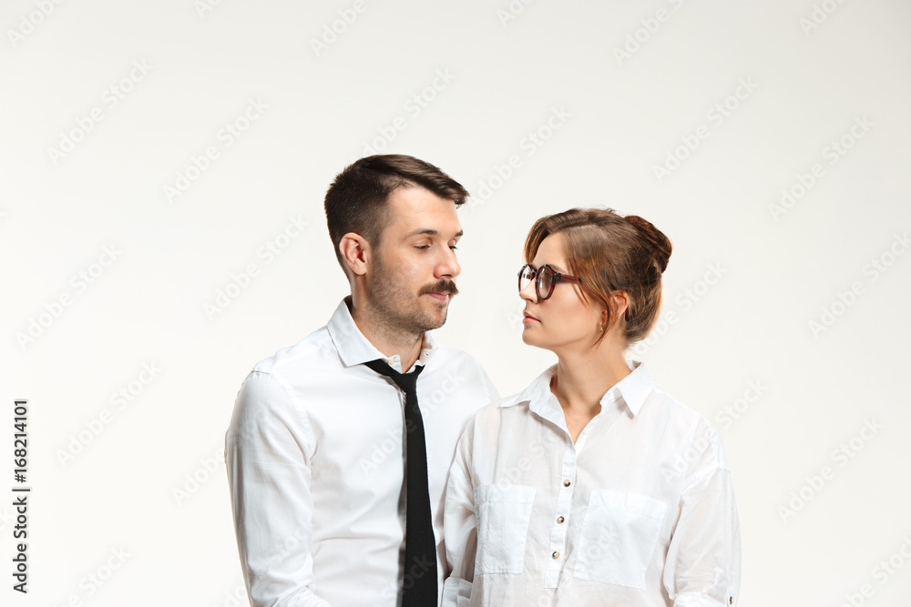 The business man and woman communicating on a gray background The business man and woman communicating on a gray background