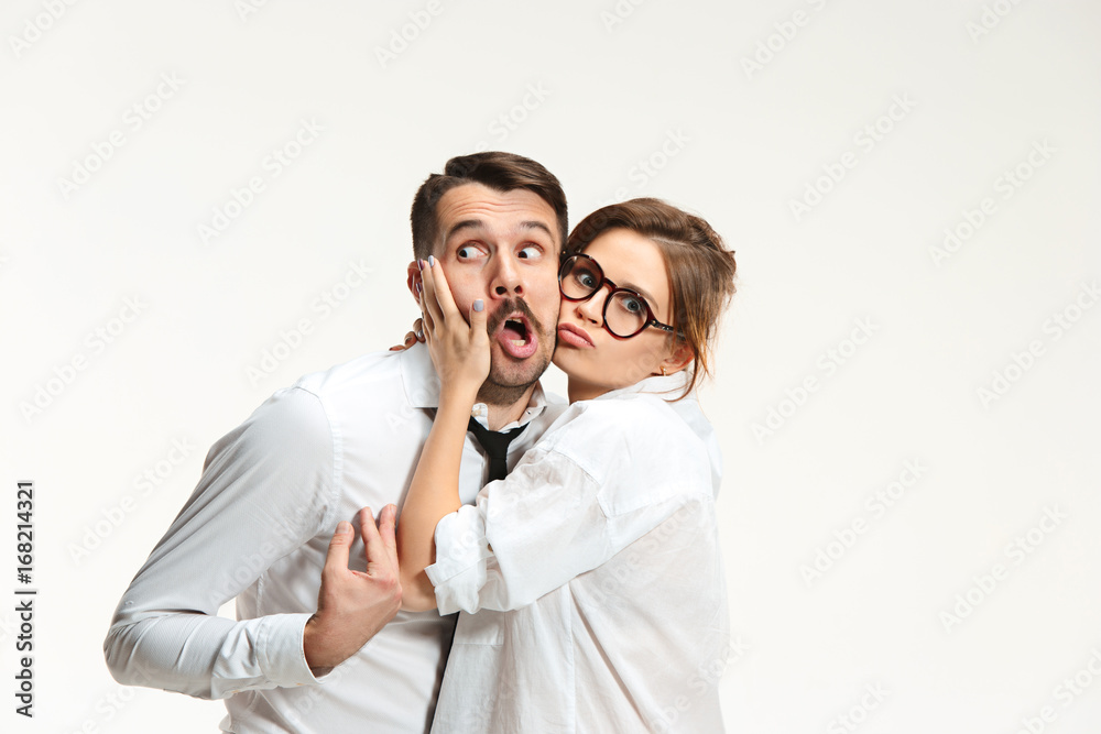The business man and woman communicating on a gray background The business man and woman communicating on a gray background