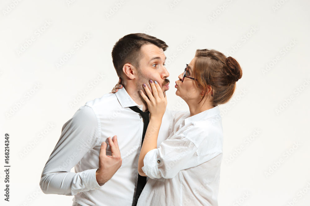 The business man and woman communicating on a gray background The business man and woman communicating on a gray background