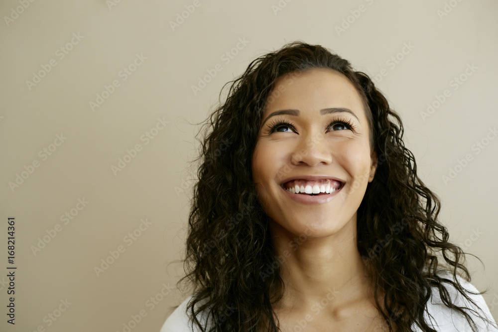 Portrait of smiling Mixed Race woman looking up Portrait of smiling Mixed Race woman looking up