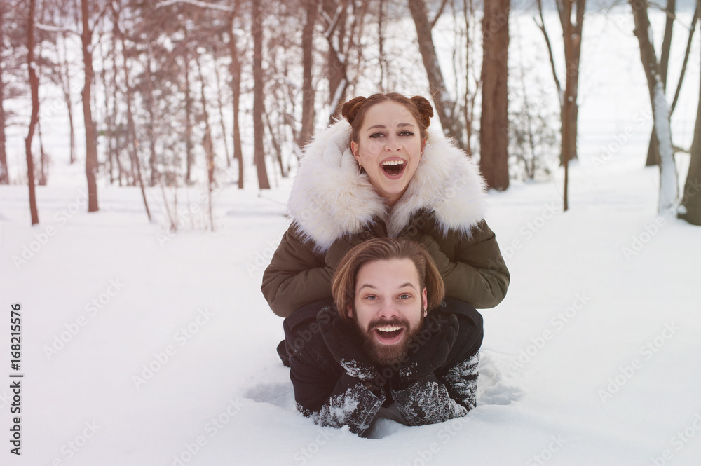 Cheerful young couple having fun in winter park Cheerful young couple having fun in winter park