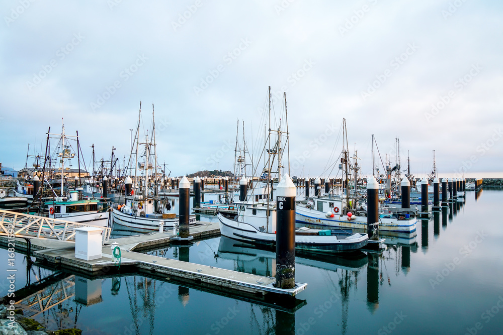 A bunch of fishing boats waiting for the next trip to where the fish are.