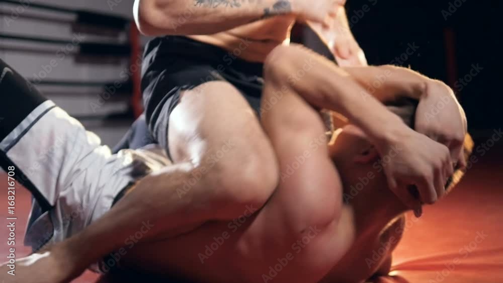 Two fighters train on a boxing ring floor. Two fighters train on a boxing ring floor.