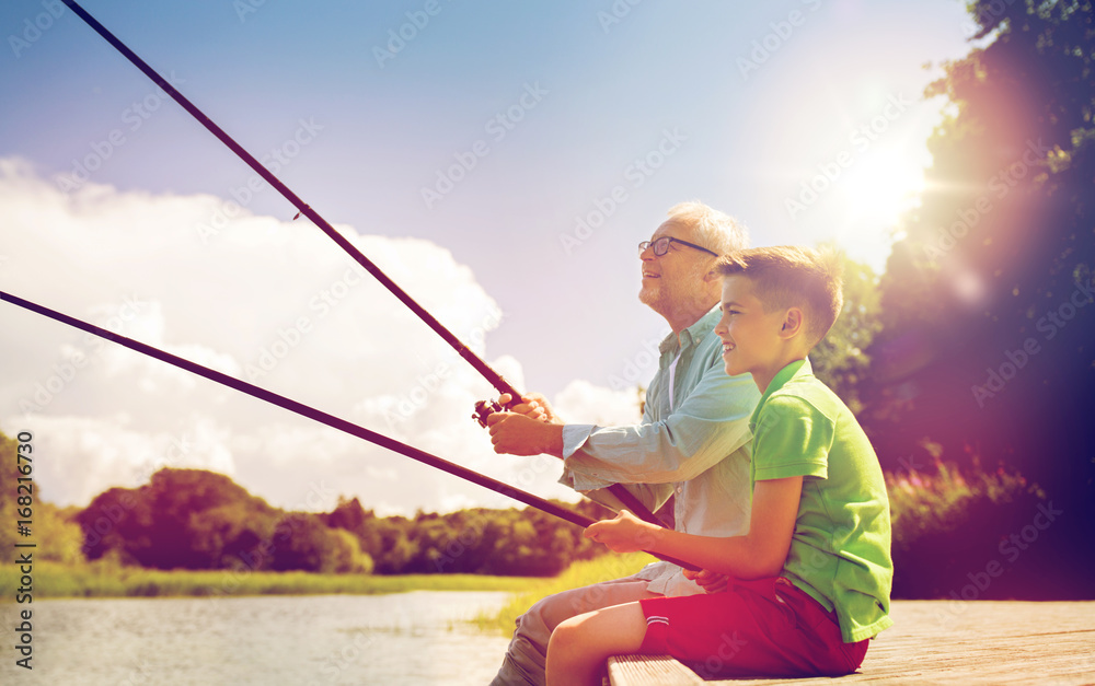 grandfather and grandson fishing on river berth grandfather and grandson fishing on river berth