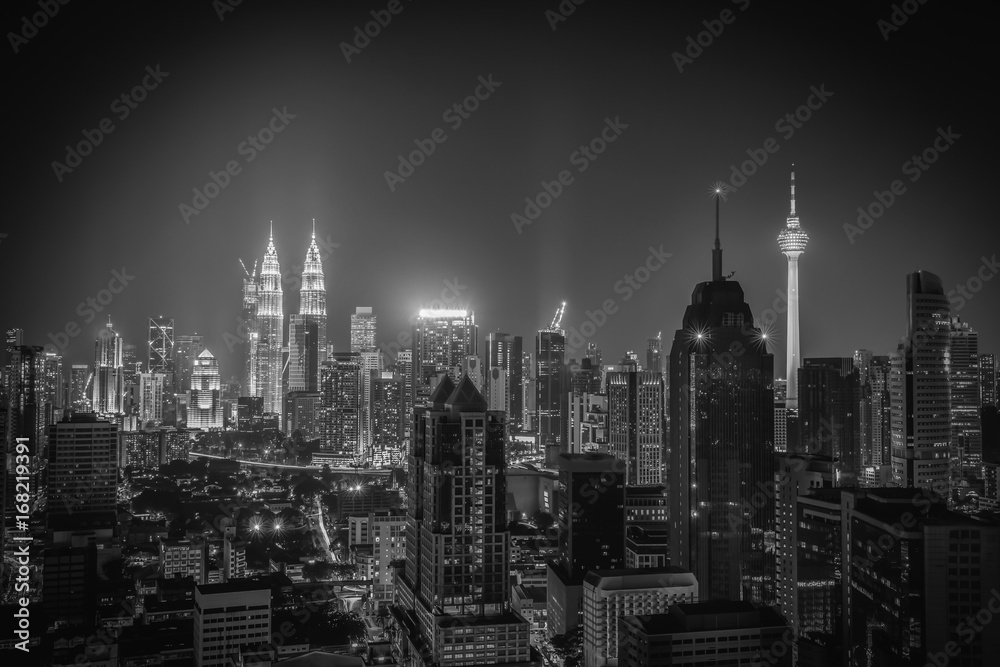 Black and white image of Kuala lumpur city skyline at night in Malaysia.