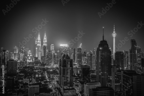 Black and white image of Kuala lumpur city skyline at night in Malaysia. © nuttawutnuy