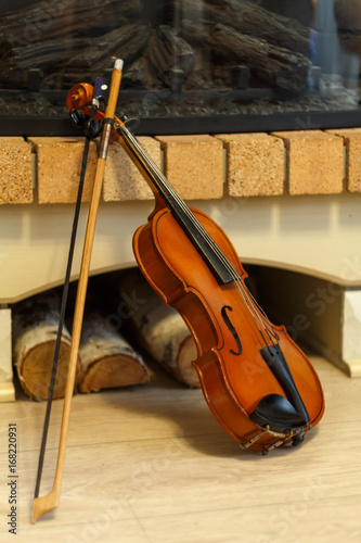 old violin by the fireplace